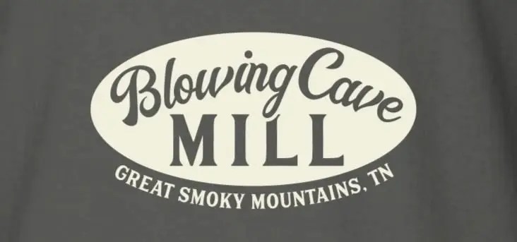 Blowing Cave Mill logo, Great Smoky Mountains, TN, on a gray background.