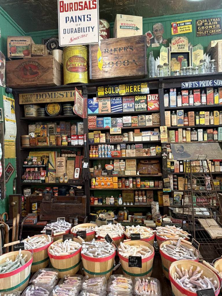 Vintage general store with shelves full of old products and baskets of laundry soap bars.