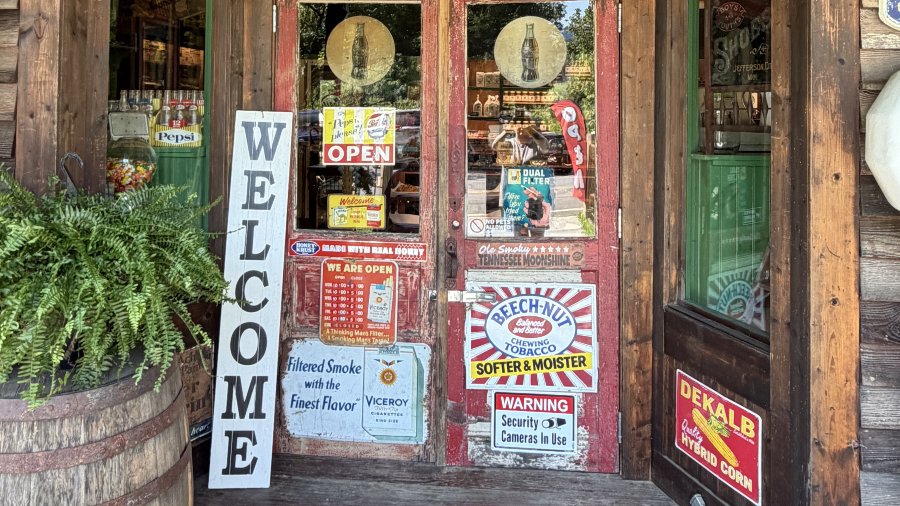 Rustic store entrance with welcome sign and vintage decor.